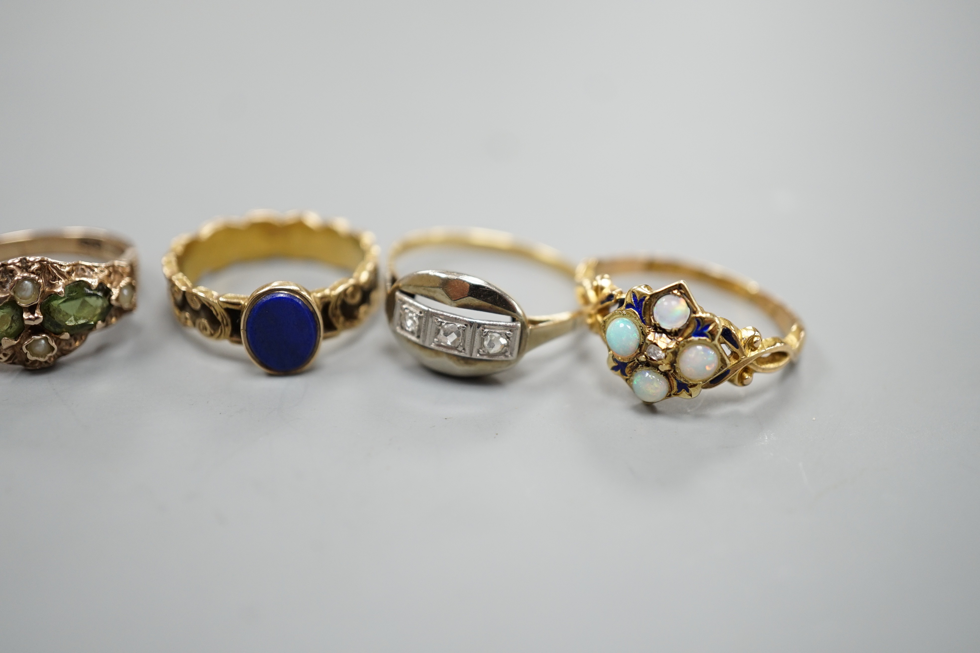 Five assorted early 20th century and later gem set rings, including 15ct white opal and enamel size O, gross weight 2.6 grams, a 585 emerald and white stone ring, gross 2 grams and three others including 9ct gold, gross